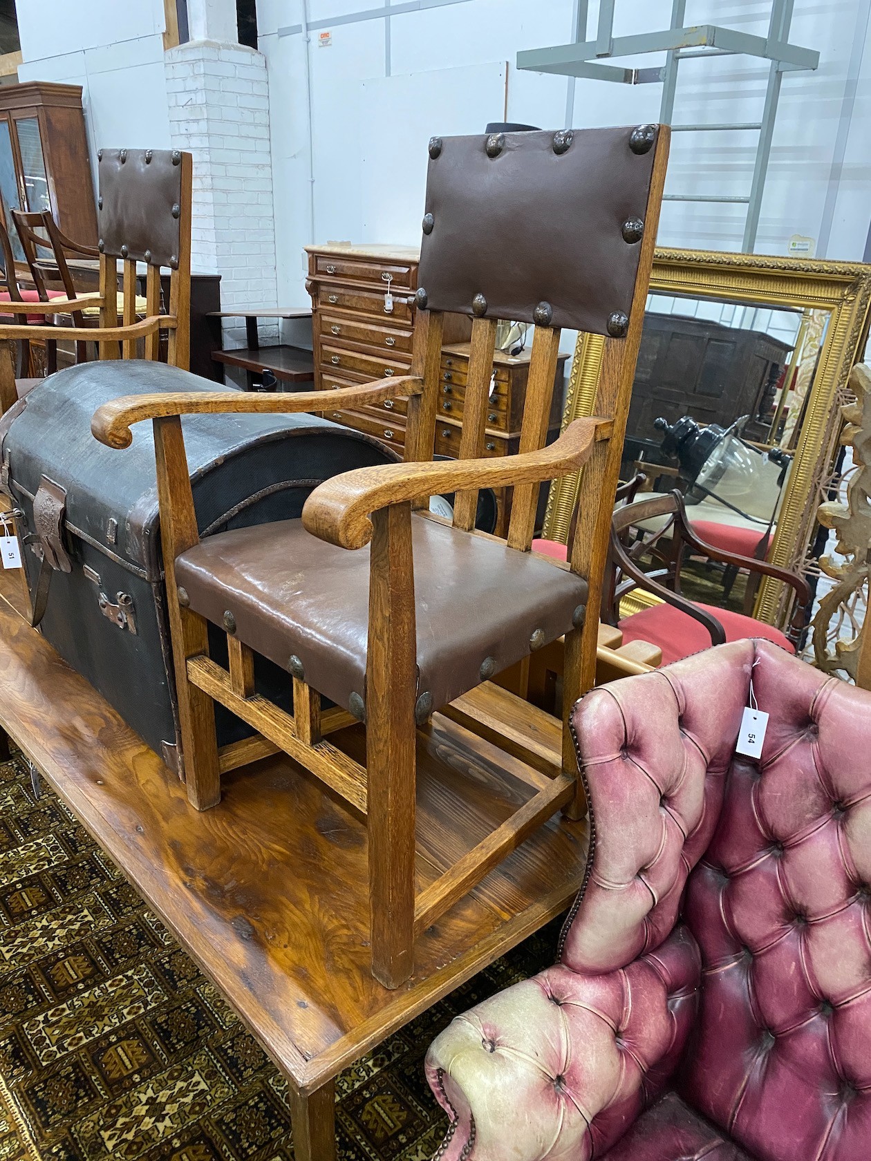 A pair of Arts & Crafts oak elbow chairs, width 58cm, depth 49cm, height 97cm